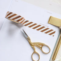 Scissors on top of Ponderlily Meeting Notebook Action Items using decorative tape
