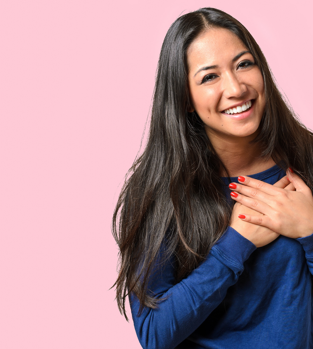 woman holding her heart in gratitude