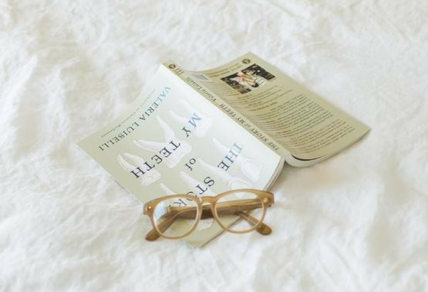 Book and glasses on bed