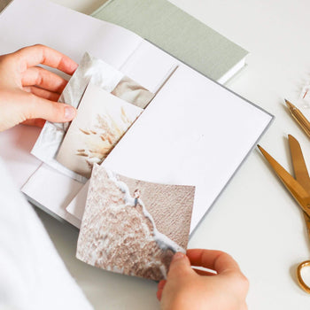 Woman adding pictures to the back pocket of planner