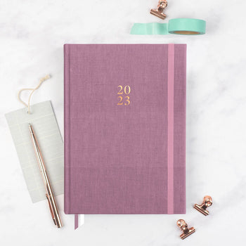 2023 mauve planner by Ponderlily on desk with accessories