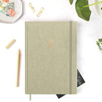 Ponderlily 2023 weekly planner Sunday start with Sage cover on table with elastic band